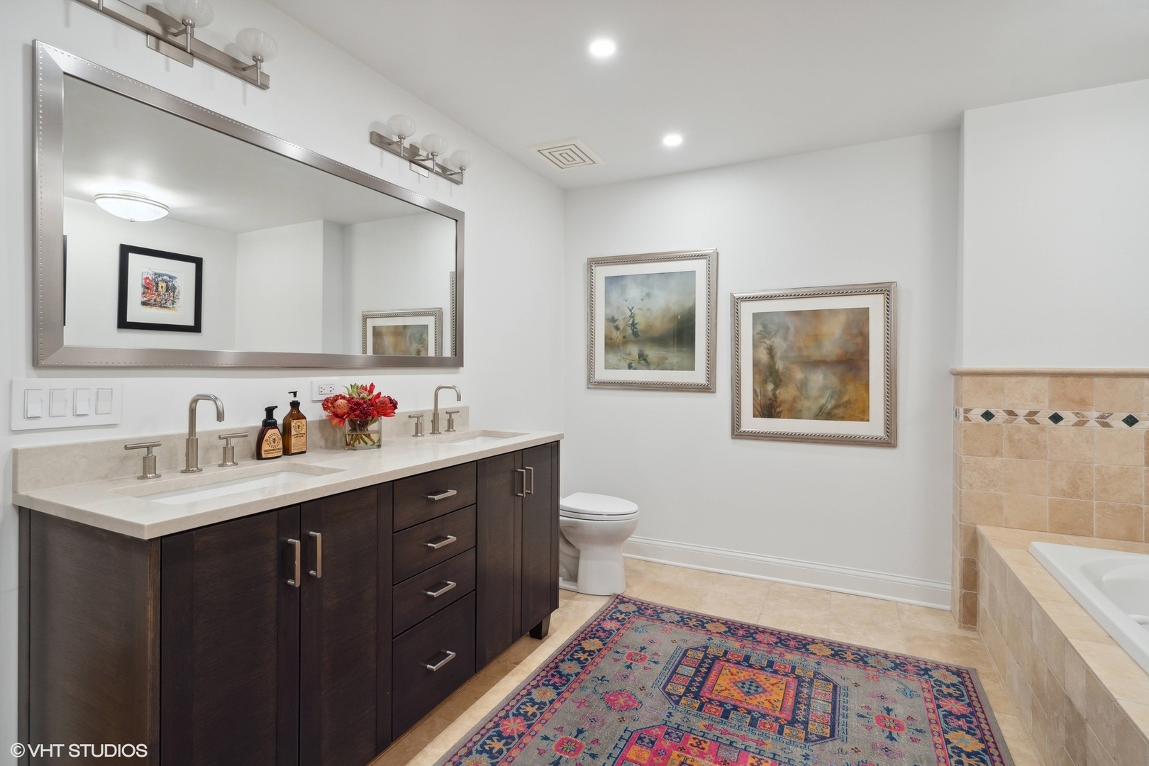 1301 North Dearborn Street, Unit 705 Chicago, IL 60610 - Photo 15 of 25 a spacious bathroom with a granite countertop sink and a mirror