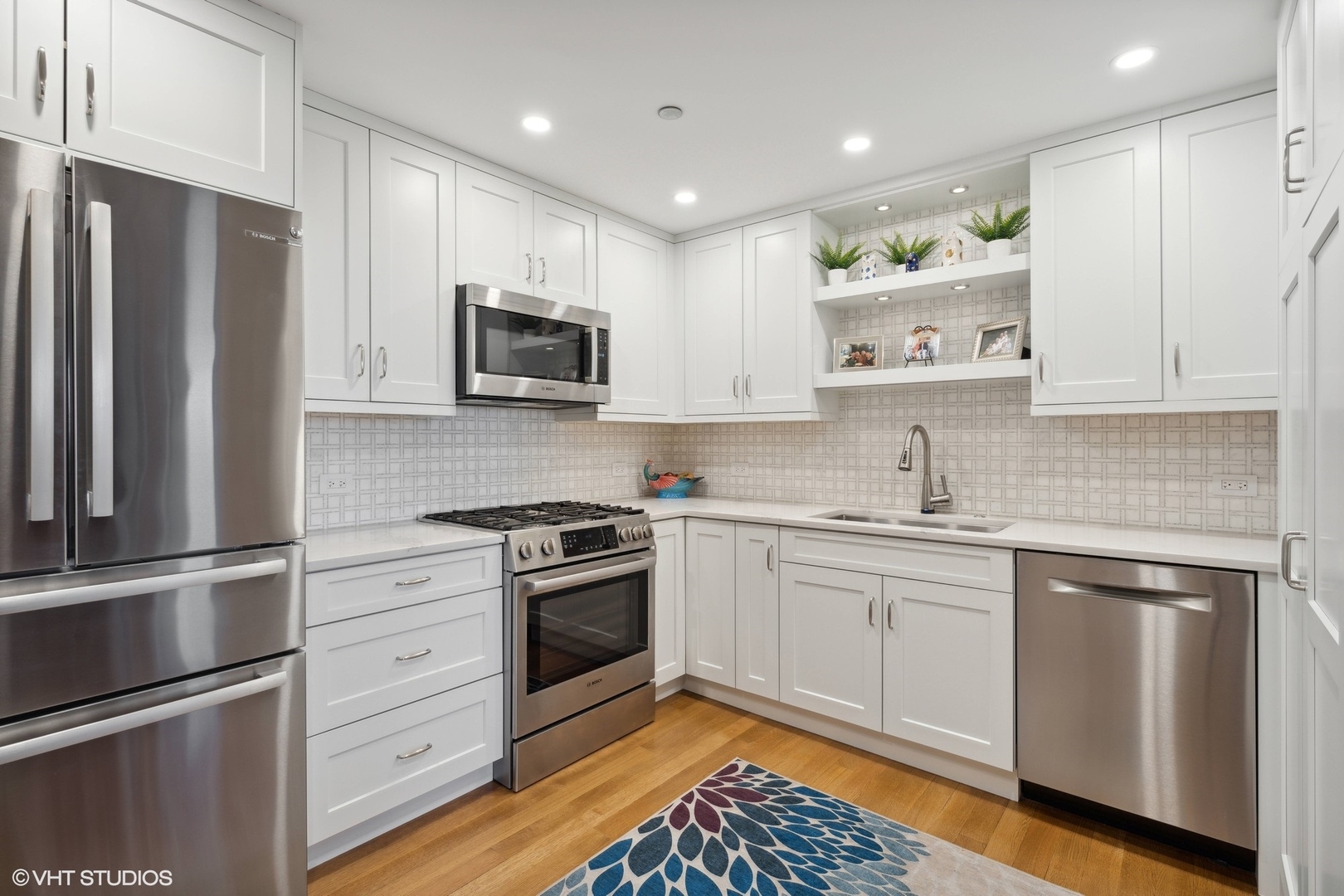 1301 North Dearborn Street, Unit 705 Chicago, IL 60610 - Photo 8 of 25 a kitchen with stainless steel appliances granite countertop a stove a sink and a refrigerator