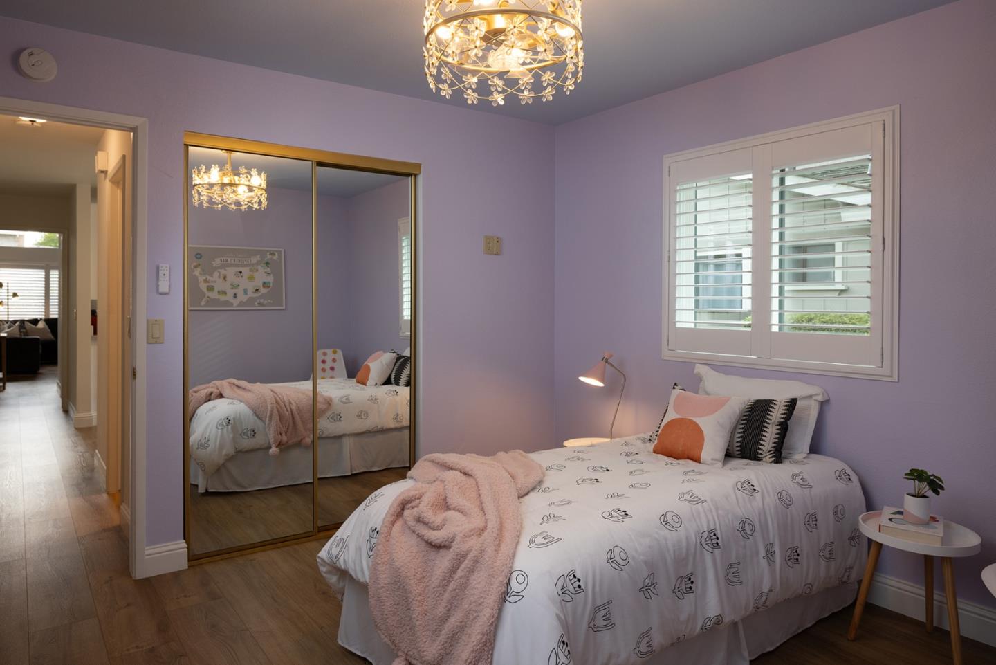 3850 Rio Road, Unit 63 Carmel, CA 93923 - Photo 13 of 19 a bedroom with a bed and a chandelier
