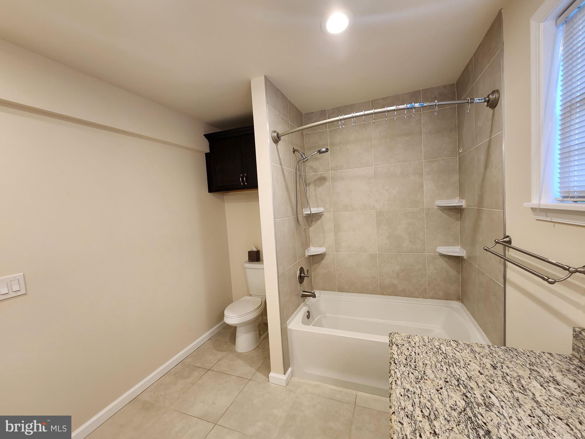 599 Cherry Road Souderton, PA 18964 - Photo 4 of 13 a bathroom with a granite countertop bathtub shower and toilet