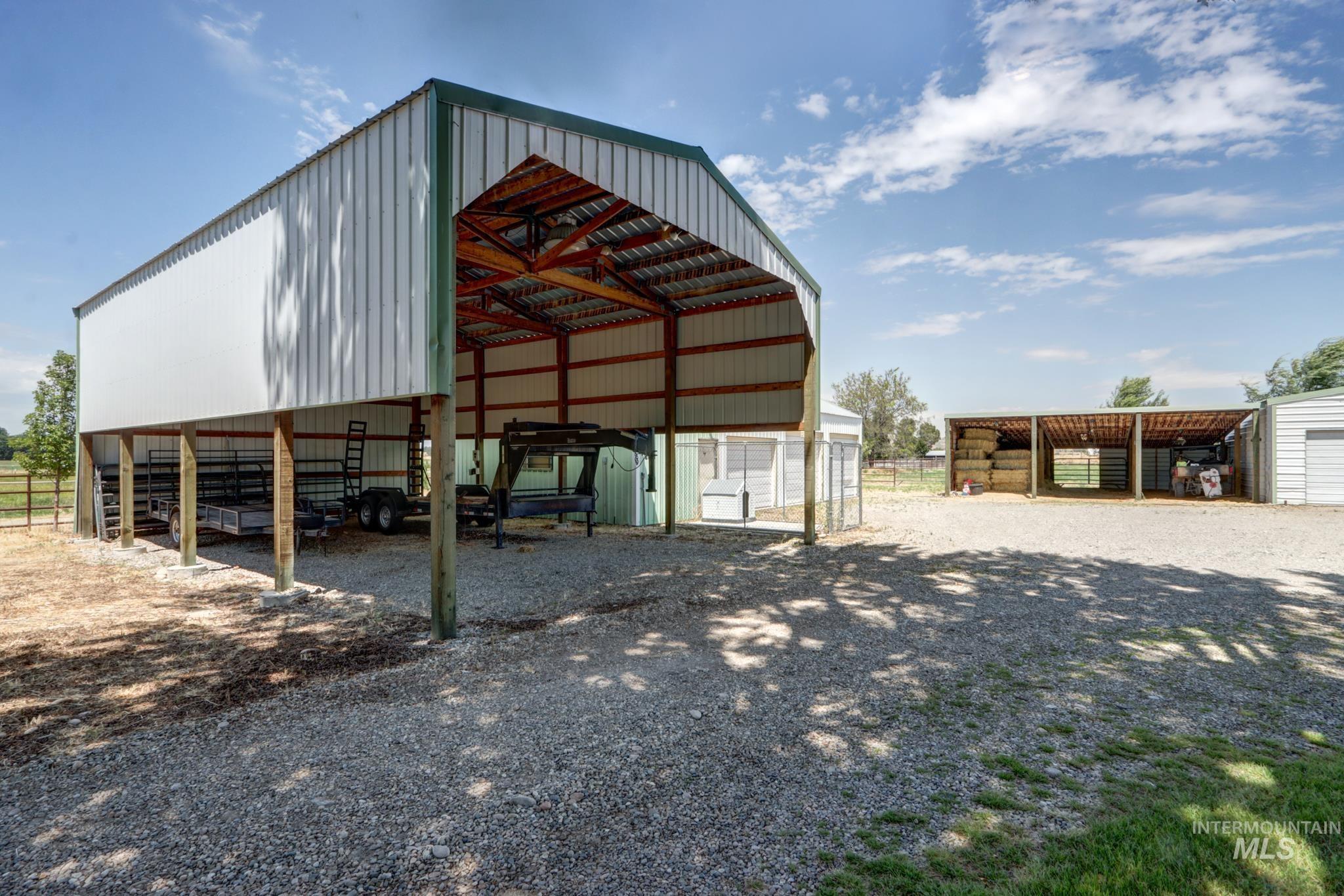2528 Waterwheel Road Emmett, ID 83617 - Photo 3 of 50 White siding residence featuring a prominent green metal roof and a covered front porch