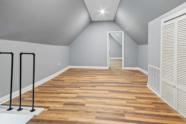 a view of a livingroom with wooden floor and stairs