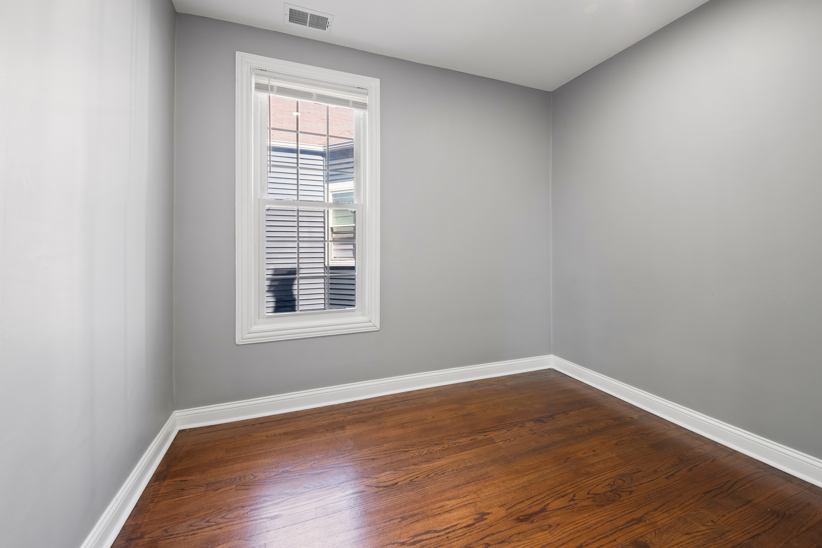 4251 North Lawndale Avenue, Unit 2 Chicago, IL 60618 - Photo 13 of 20 an empty room with wooden floor and windows