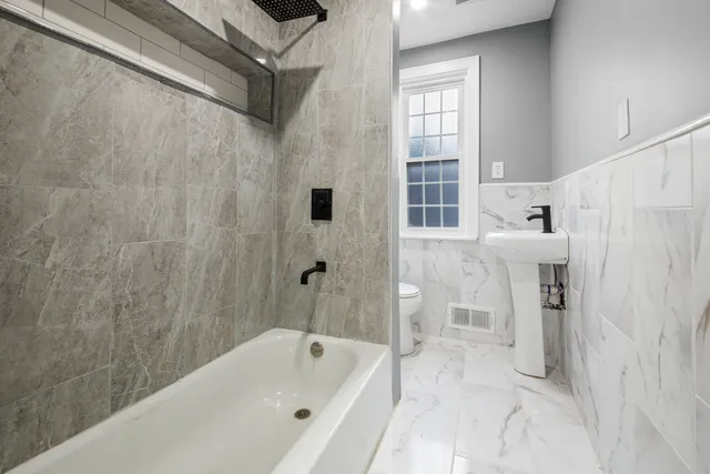 a bathroom with a bathtub and a shower