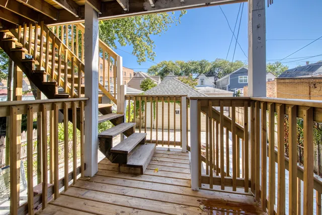 a view of a balcony with wooden floor