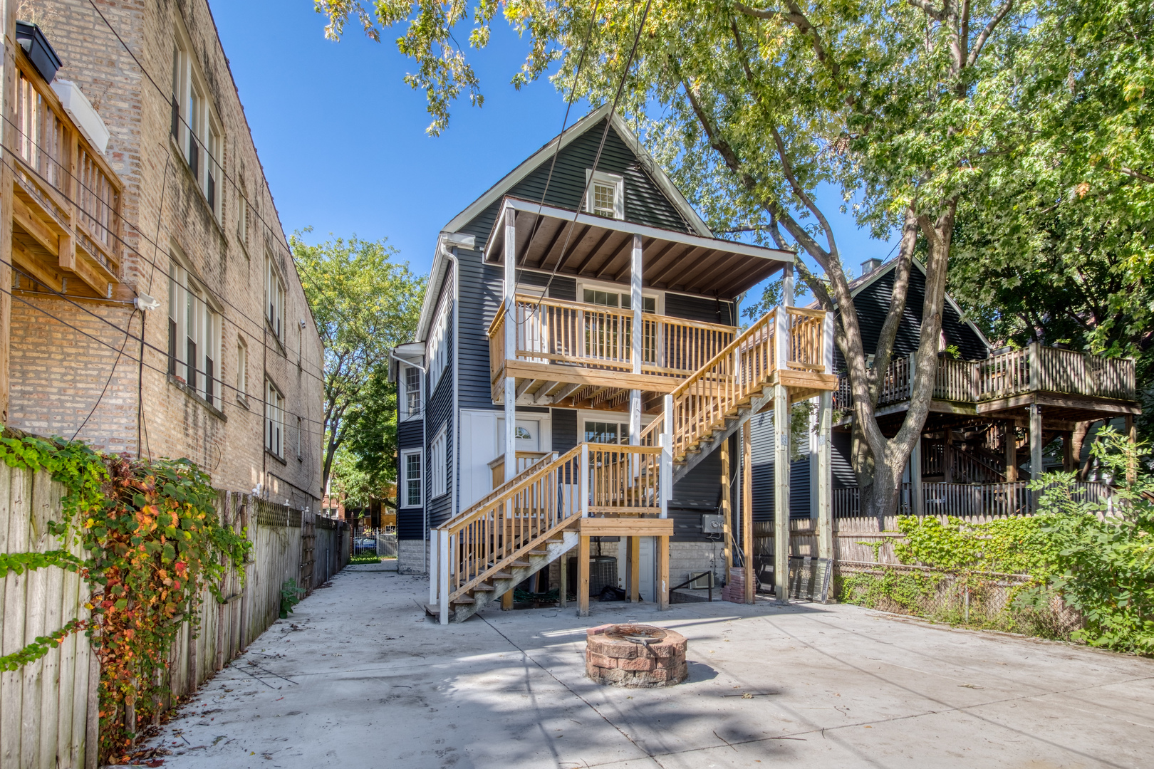 4251 North Lawndale Avenue, Unit 2 Chicago, IL 60618 - Photo 2 of 20 a view of a house with a small yard and wooden fence