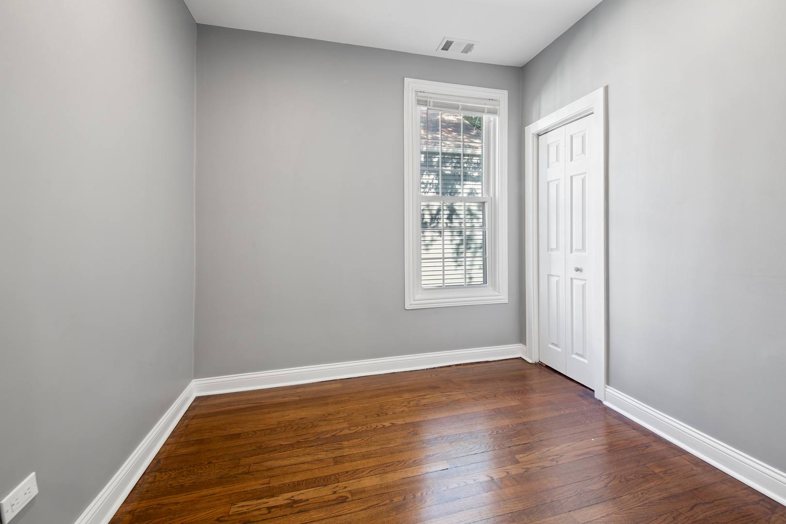 4251 North Lawndale Avenue, Unit 2 Chicago, IL 60618 - Photo 8 of 20 an empty room with wooden floor and windows