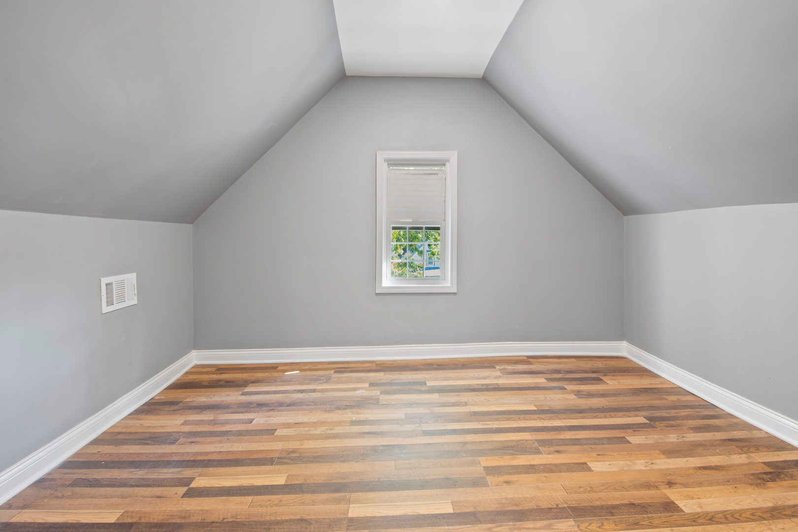 4251 North Lawndale Avenue, Unit 2 Chicago, IL 60618 - Photo 10 of 20 a view of an empty room with wooden floor and a window