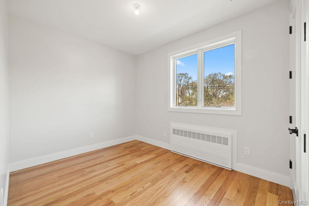5 Mirror Lake Road, Unit 201 Spring Valley, NY 10977 - Photo 29 of 49 a view of empty room with wooden floor and fan