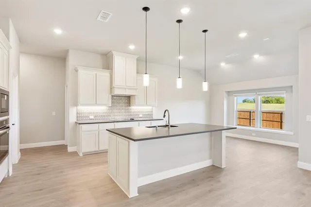 a kitchen with a sink stove and refrigerator