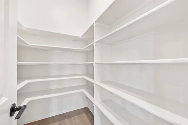 a view of walk in closet with empty racks