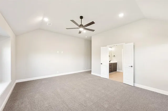 an empty room with closet and a ceiling fan