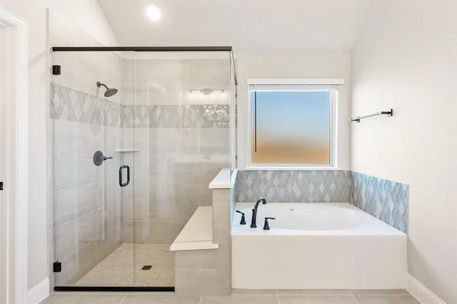 a bathroom with a bathtub and shower