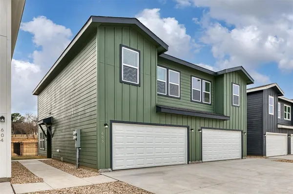 a front view of a house with a garage