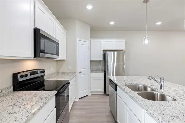 a bathroom with a granite countertop sink a mirror and a shower