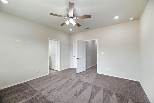 a bathroom with a granite countertop sink a toilet and a mirror