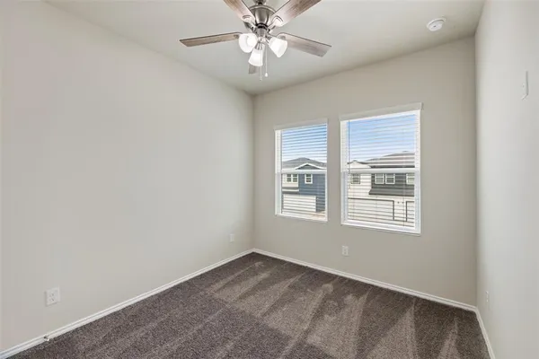 a living room with furniture kitchen view and a wooden floor