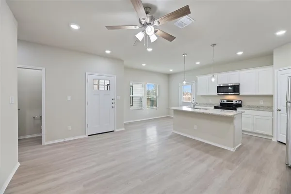 a kitchen with a sink stove and microwave