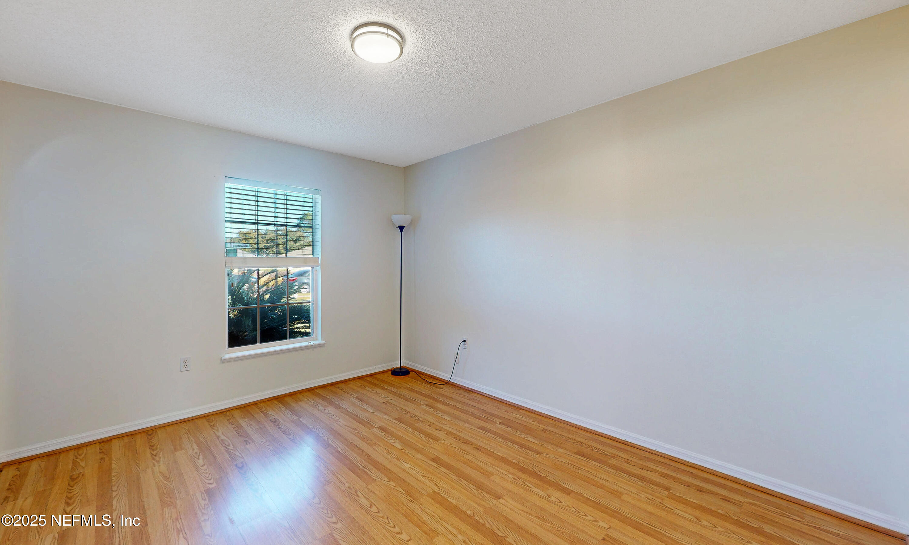 3031 Valkyrie Road Middleburg, FL 32068 - Photo 13 of 36 an empty room with wooden floor and windows