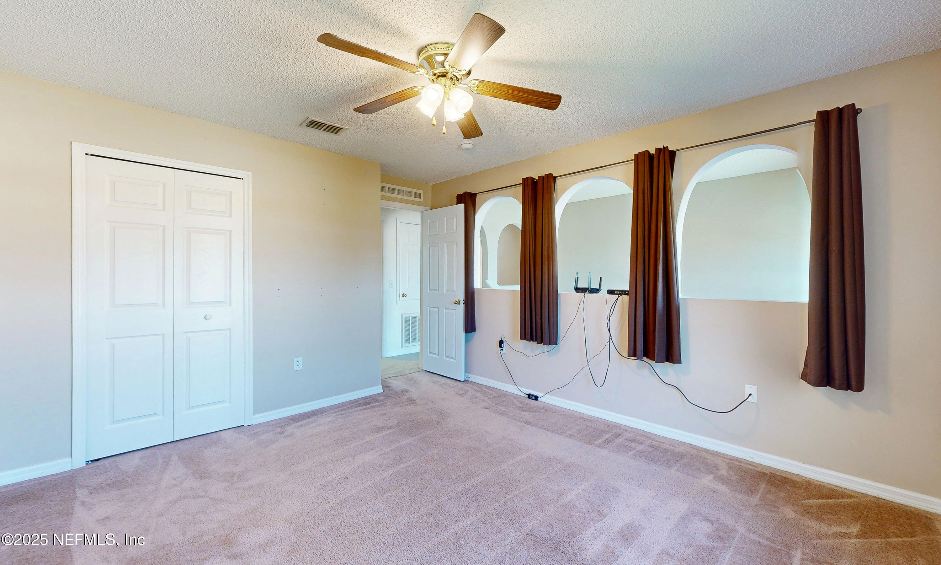 3031 Valkyrie Road Middleburg, FL 32068 - Photo 23 of 36 an empty room with ceiling fan and window