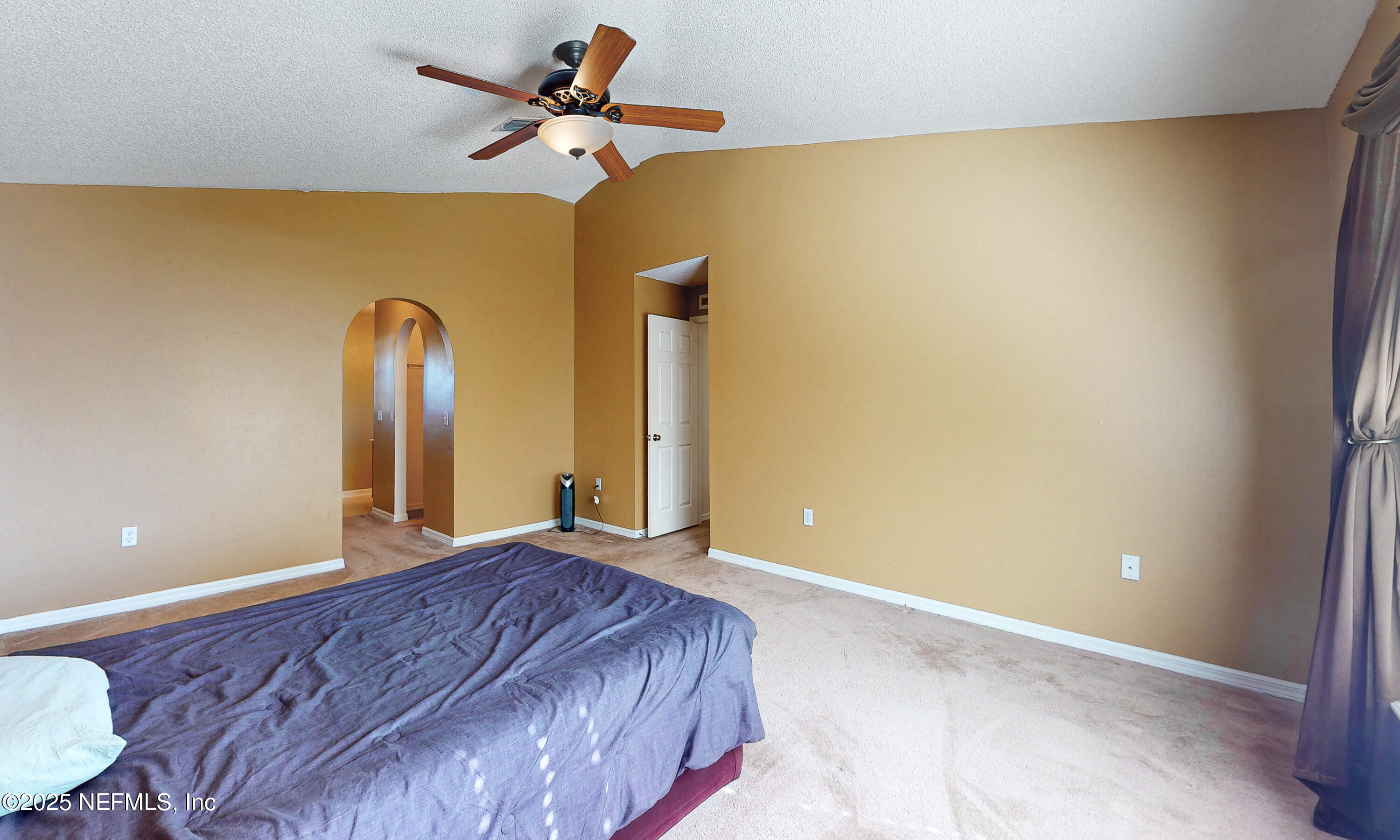 3031 Valkyrie Road Middleburg, FL 32068 - Photo 25 of 36 a bedroom with a bed and a chandelier
