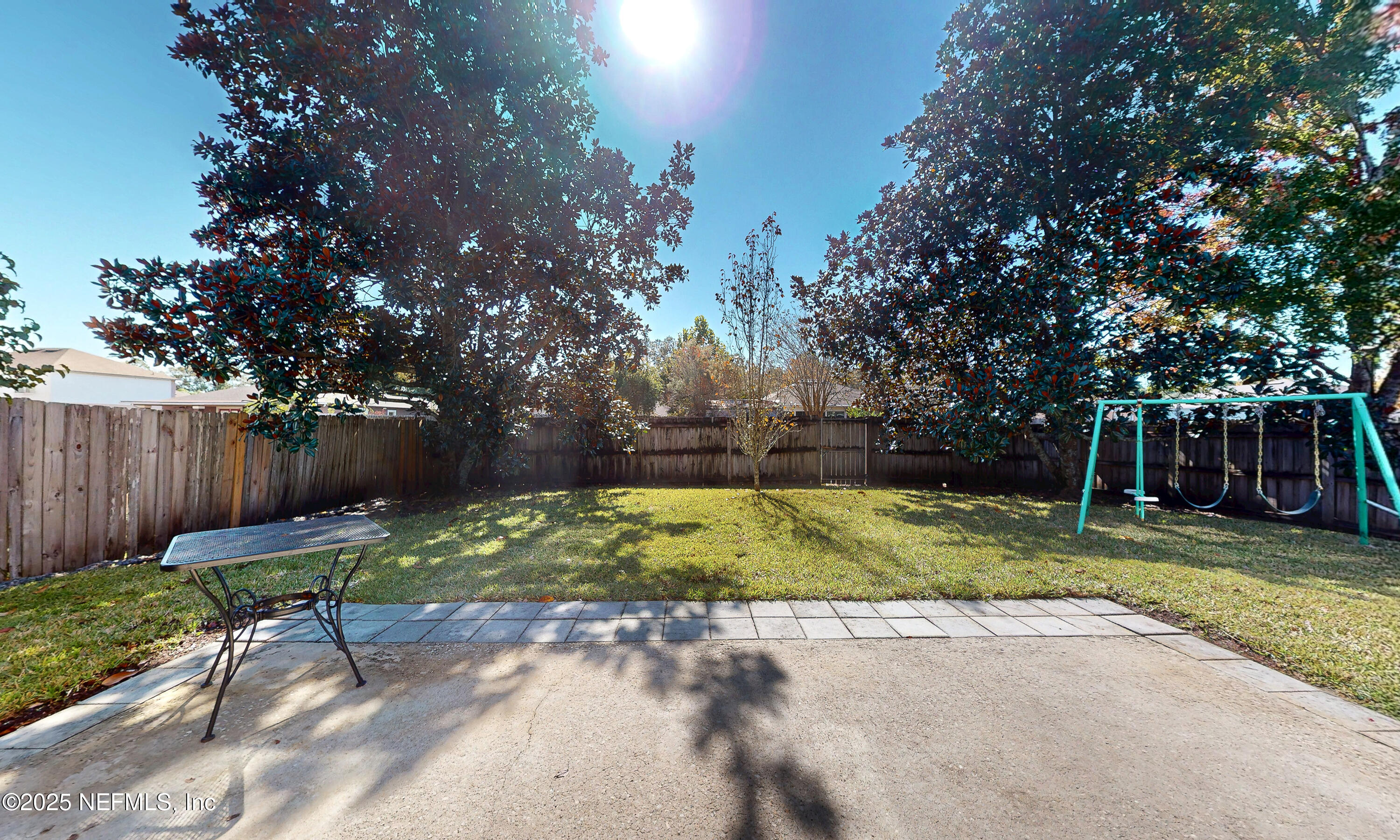 3031 Valkyrie Road Middleburg, FL 32068 - Photo 32 of 36 a view of backyard with table and chairs and wooden fence