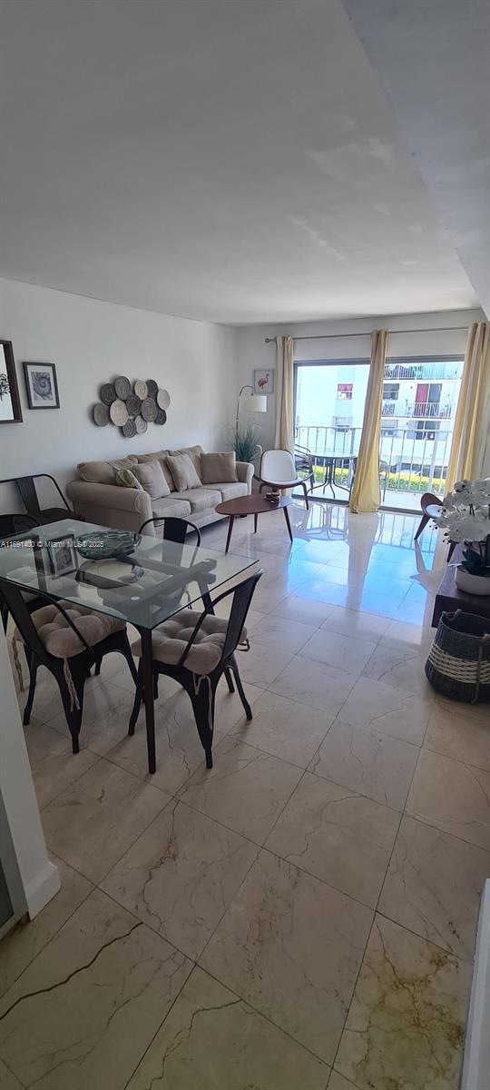 1300 Alton Road, Unit 3D Miami Beach, FL 33139 - Photo 2 of 11 a living room with furniture and a large window
