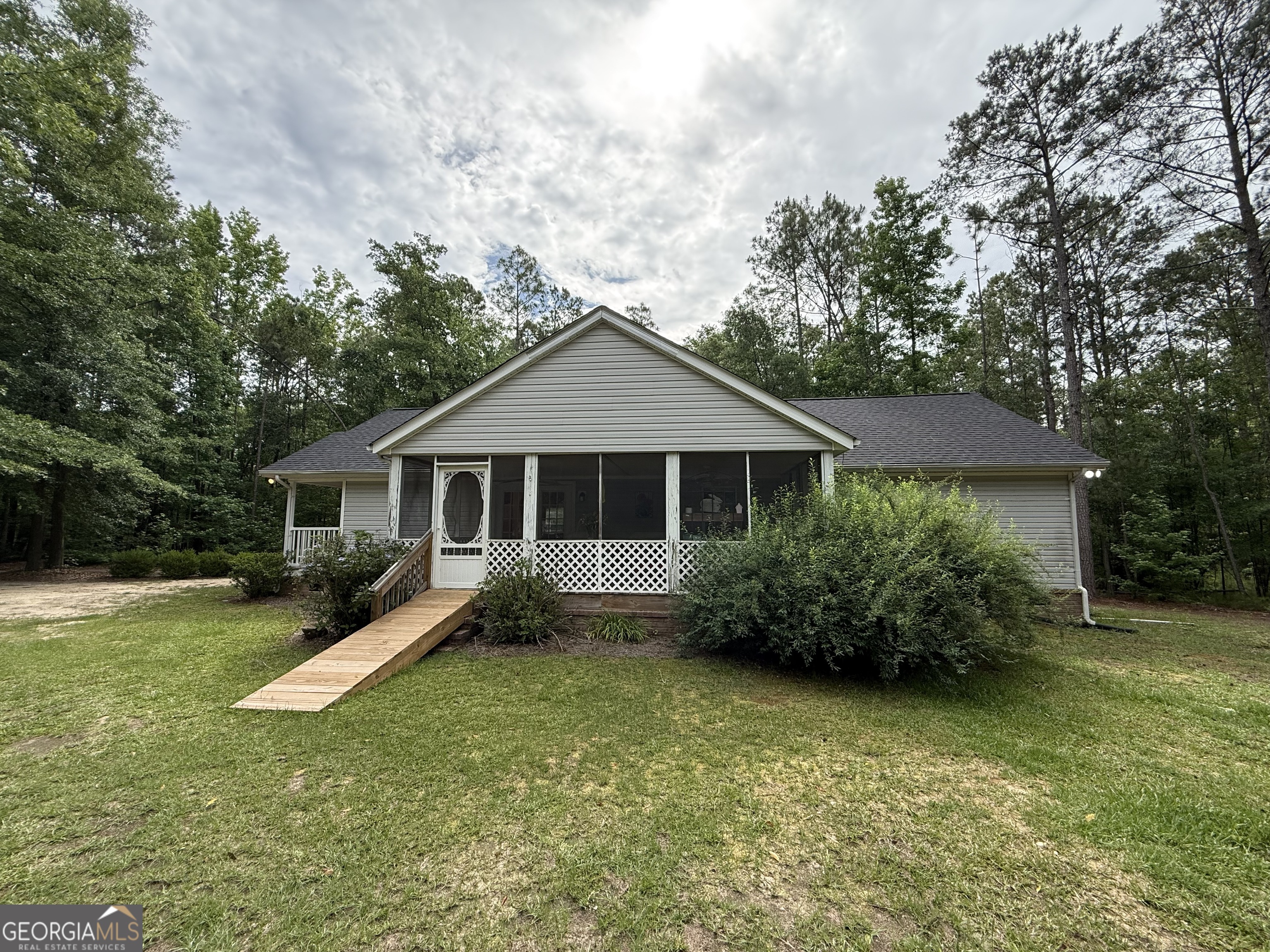 1081 Marshall Church Road Thomson, GA 30824 - Photo 22 of 26 a front view of a house with a garden