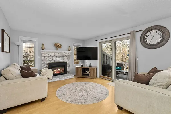 a living room with furniture a fireplace and a flat screen tv