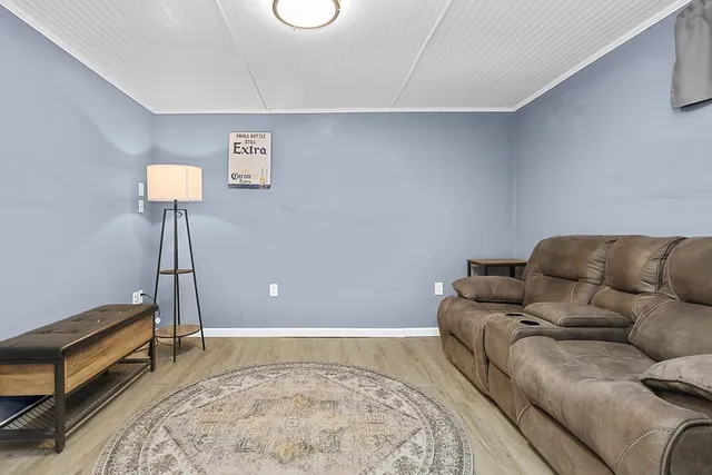 a living room with a couch and a chandelier