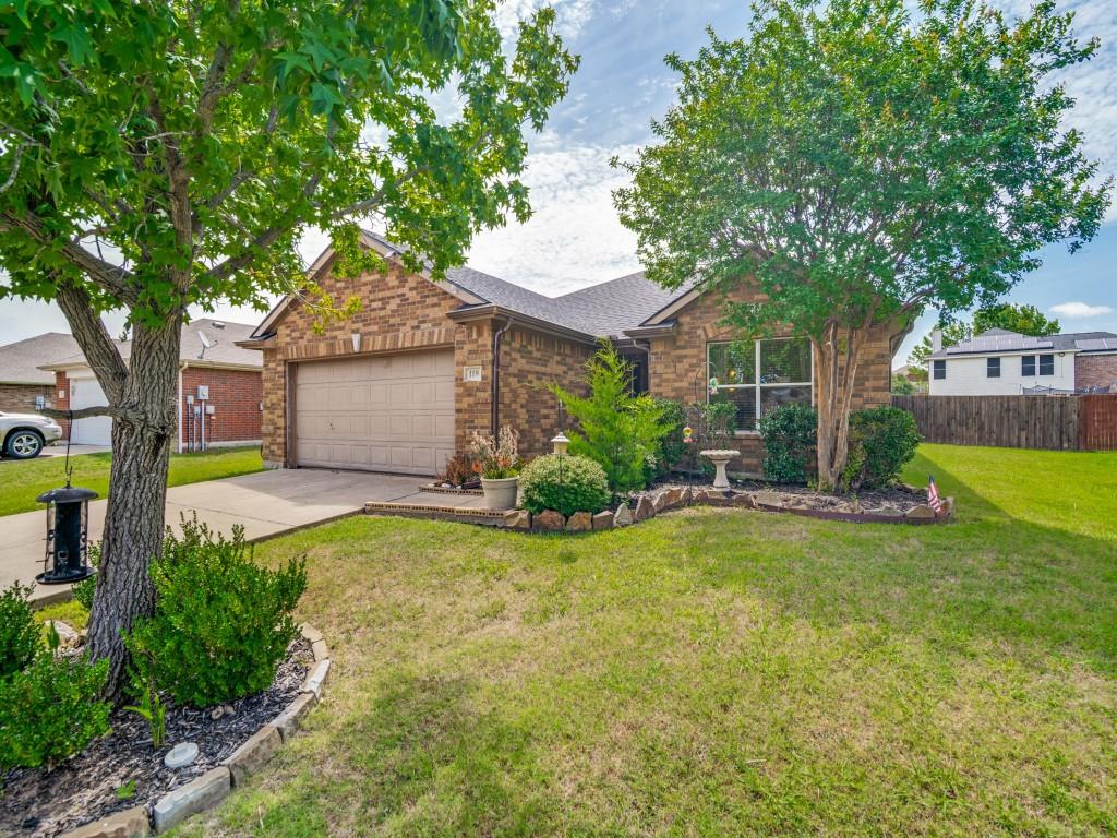 119 Robin Lane Forney, TX 75126 - Photo 1 of 27 Brick facade residence featuring a two-car garage, mature front yard trees, and a concrete driveway