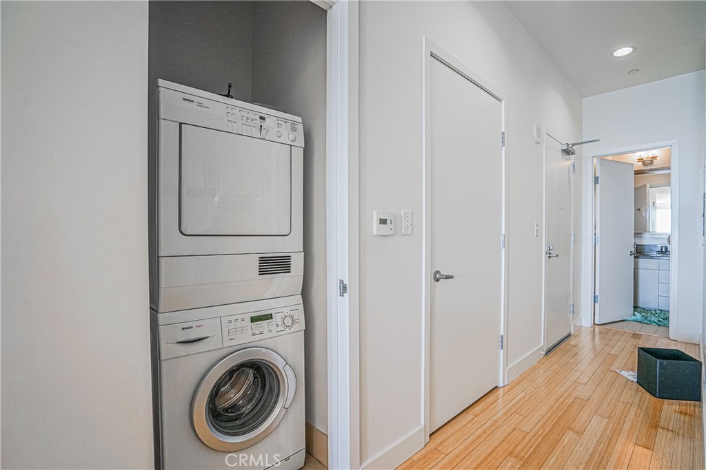 3810 Wilshire Boulevard, Unit 1409 Los Angeles, CA 90010 - Photo 16 of 41 a view of a hallway with washer and dryer