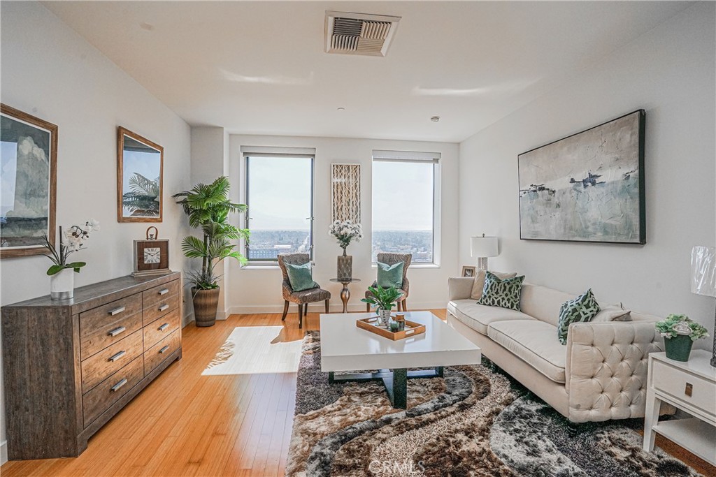 3810 Wilshire Boulevard, Unit 1409 Los Angeles, CA 90010 - Photo 18 of 41 a living room with furniture and wooden floor