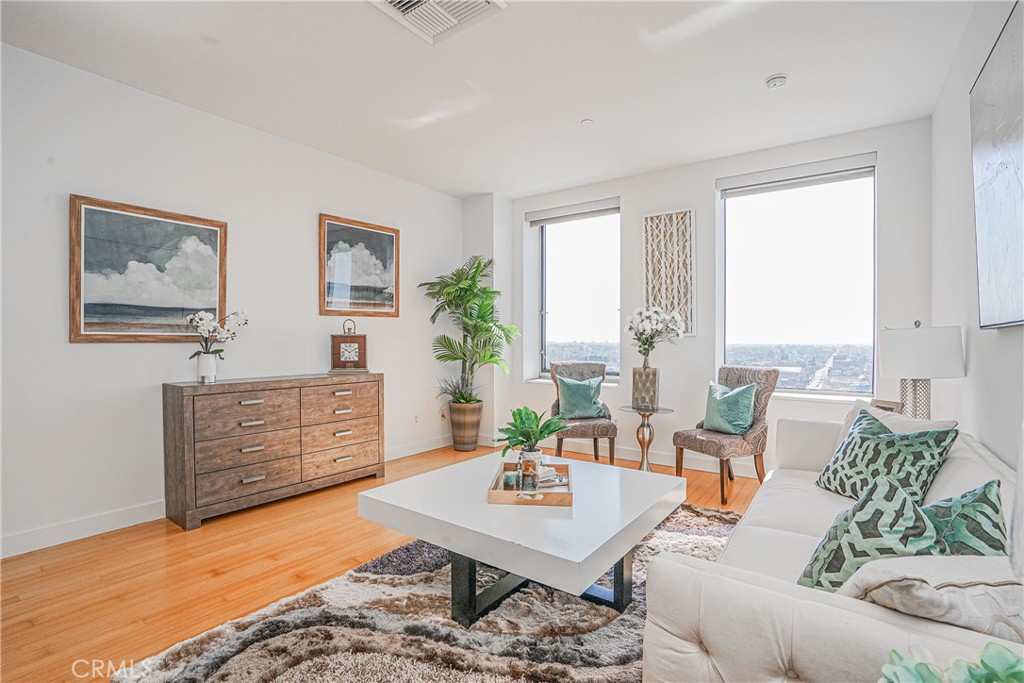 3810 Wilshire Boulevard, Unit 1409 Los Angeles, CA 90010 - Photo 2 of 41 a living room with furniture rug and window