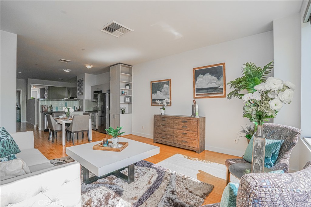 3810 Wilshire Boulevard, Unit 1409 Los Angeles, CA 90010 - Photo 21 of 41 a living room with furniture potted plant and a table