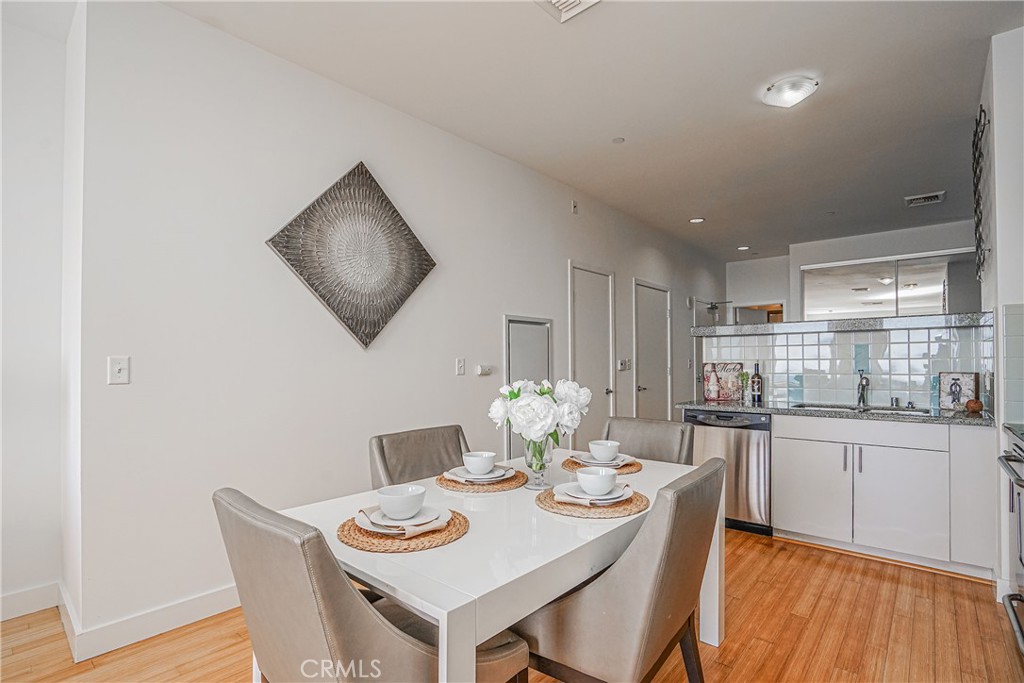 3810 Wilshire Boulevard, Unit 1409 Los Angeles, CA 90010 - Photo 25 of 41 a view of a dining room with furniture window and wooden floor