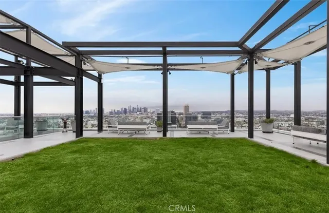 a swimming pool with lawn chairs and a big yard