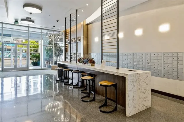 a dining hall with stainless steel appliances granite countertop a granite counter tops and a view of living room