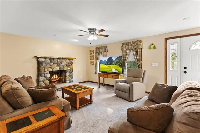 a living room with furniture a fireplace and a flat screen tv