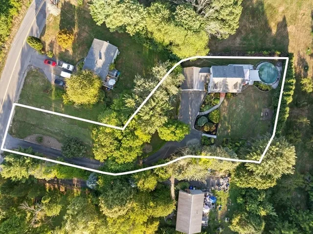 a view of deck with table and chairs under an umbrella