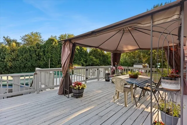 a view of a wooden deck with a yard