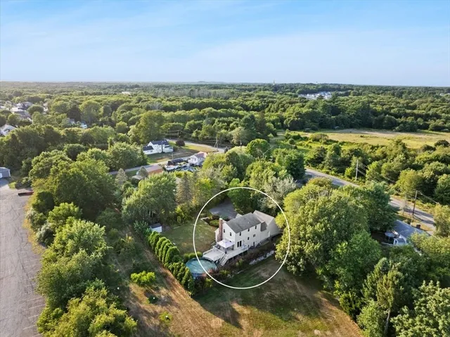 an aerial view of residential houses with outdoor space and swimming pool