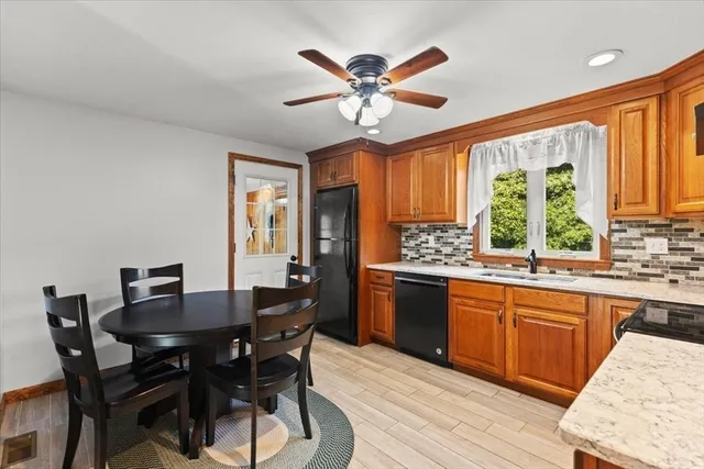 a dining room with a wooden table and chairs