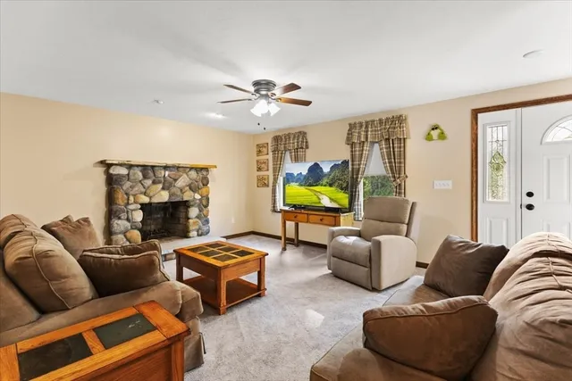 a living room with furniture a fireplace and a flat screen tv