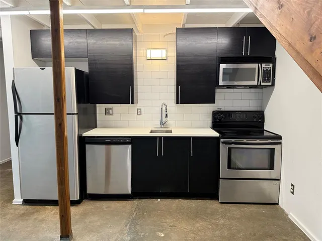 a kitchen with a refrigerator sink and stove