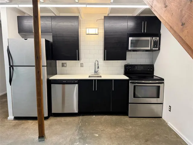 a kitchen with stainless steel appliances a refrigerator and a stove