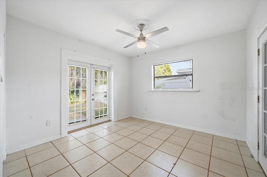 10971 57th Avenue Seminole, FL 33772 - Photo 14 of 26 a view of an empty room with window and chandelier fan