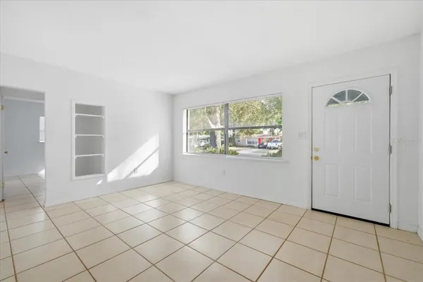 an empty room with windows and closet