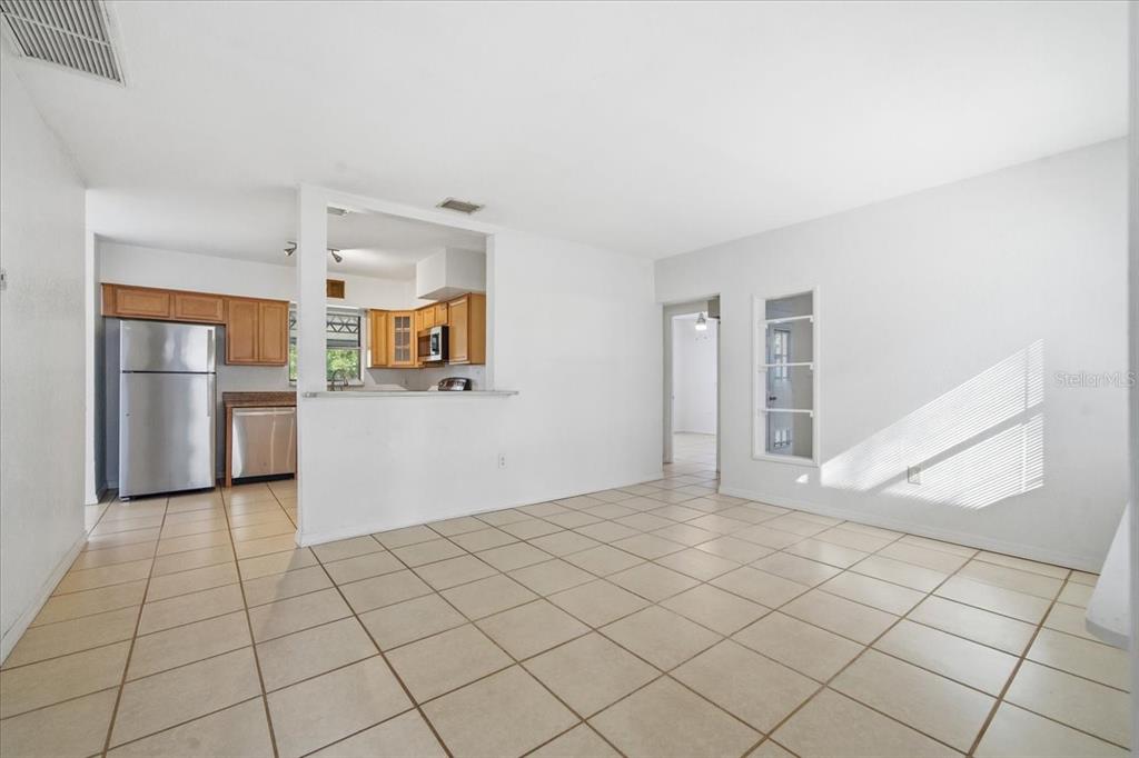 10971 57th Avenue Seminole, FL 33772 - Photo 3 of 26 a view of a kitchen with a sink and an empty room