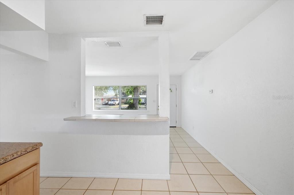 10971 57th Avenue Seminole, FL 33772 - Photo 5 of 26 a view of a hallway with wooden floor and a large window